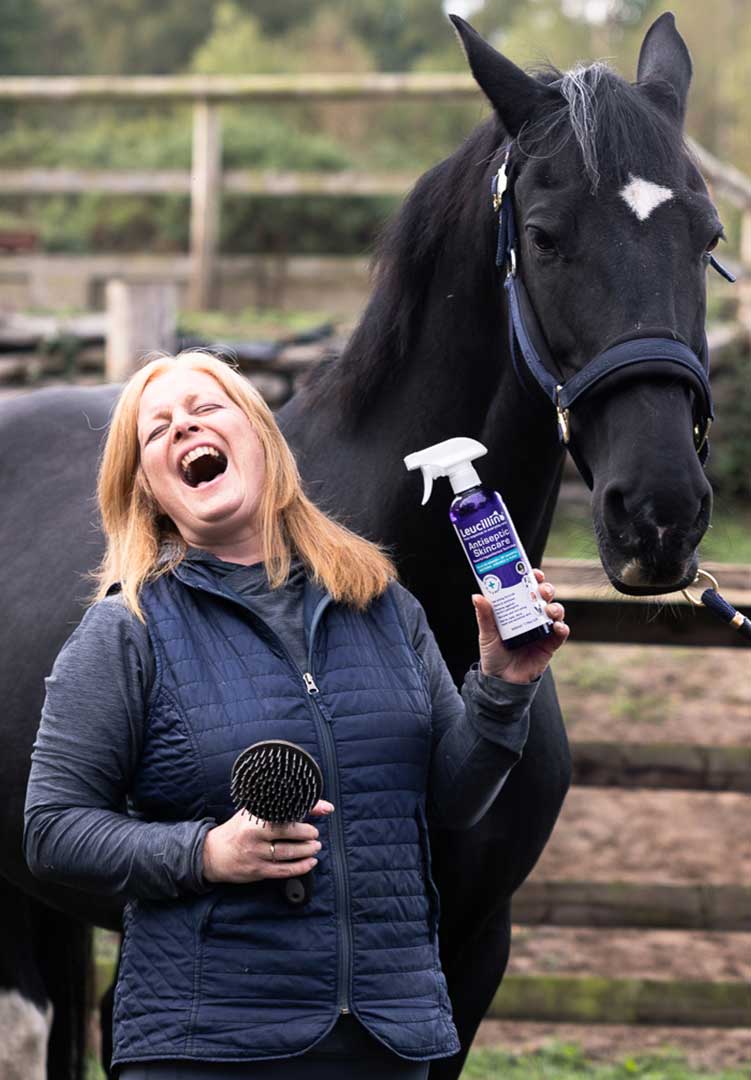 Lady holding a Leucillin bottle with a horse
